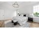 Bright bedroom with a modern chandelier, plush bedding, and ample natural light at 1817 Union St, Charlotte, NC 28205