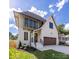 Modern home exterior with white brick, a curved roofline, and a brown garage door at 1817 Union St, Charlotte, NC 28205