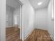 Bright hallway featuring hardwood floors, white walls, and doorway leading to another room at 1817 Union St, Charlotte, NC 28205