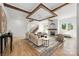 Bright and airy living room featuring a coffered ceiling with exposed wooden beams and a cozy fireplace at 1817 Union St, Charlotte, NC 28205