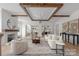 Bright, open living room with wood beam ceiling, fireplace, and hardwood floors perfect for entertaining or cozy Gathering time at 1817 Union St, Charlotte, NC 28205