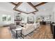 Bright, open living room with wood beam ceiling, fireplace, and hardwood floors perfect for entertaining or cozy Gathering time at 1817 Union St, Charlotte, NC 28205