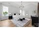 A serene main bedroom with tray ceiling, chandelier, and ample natural light creates a relaxing retreat at 1817 Union St, Charlotte, NC 28205