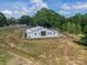 Angle of the back of the property shows the white house, the metal roof, and the land at 2003 Briarwood Cir, Fort Mill, SC 29715