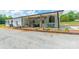 Covered patio area with ceiling fans and outdoor seating next to a landscaped garden at 2003 Briarwood Cir, Fort Mill, SC 29715