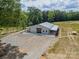 Angle of property with surrounding trees, greenery, and newly graveled driveway at 2003 Briarwood Cir, Fort Mill, SC 29715