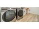 Well-equipped laundry room with modern washer and dryer, complemented by a functional countertop and cabinets at 2003 Briarwood Cir, Fort Mill, SC 29715
