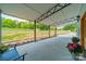 Covered porch area with a view of a grassy lawn and a storage building in the distance at 2003 Briarwood Cir, Fort Mill, SC 29715