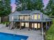 Stunning backyard view showcasing in-ground pool, covered patio, and the home's unique architecture at 208 Wellington Dr, Lincolnton, NC 28092