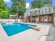 Spacious backyard features an in-ground pool with a diving board and a covered patio at 208 Wellington Dr, Lincolnton, NC 28092