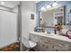 Bathroom featuring a vanity, mirror with lights, and a shower with a blue pattern curtain at 208 Wellington Dr, Lincolnton, NC 28092
