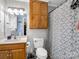 Bathroom with wood-look cabinets and a shower with a patterned curtain at 208 Wellington Dr, Lincolnton, NC 28092