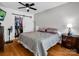 Well-lit bedroom features hardwood floors, a ceiling fan, and closet with sliding barn door at 208 Wellington Dr, Lincolnton, NC 28092