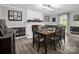 Formal dining room with a white brick fireplace, modern lighting, and seating for eight at 208 Wellington Dr, Lincolnton, NC 28092
