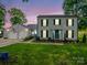 Charming two-story home with a spacious two-car garage and a well-manicured lawn at dusk at 208 Wellington Dr, Lincolnton, NC 28092