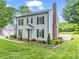 Charming two-story home with a brick chimney and beautifully landscaped front yard at 208 Wellington Dr, Lincolnton, NC 28092