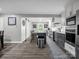 Open kitchen with gray cabinets, stainless appliances, a center island with seating, and sliding barn door at 208 Wellington Dr, Lincolnton, NC 28092