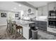 Modern kitchen featuring stainless steel appliances, a spacious island with bar seating, and stylish gray cabinetry at 208 Wellington Dr, Lincolnton, NC 28092