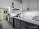 Close up of a modern kitchen featuring stainless appliances, light countertops and dark gray cabinets at 208 Wellington Dr, Lincolnton, NC 28092