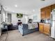 Relaxing living room features a large sectional sofa, television, fireplace, and kitchenette at 208 Wellington Dr, Lincolnton, NC 28092