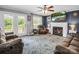 Inviting living room features a fireplace, television, ceiling fan, and comfortable seating area at 208 Wellington Dr, Lincolnton, NC 28092
