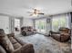 Bright living room with hardwood floors, a ceiling fan, and French doors leading to the patio at 208 Wellington Dr, Lincolnton, NC 28092