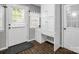 Well-lit mud room area features a built-in desk, cabinets, and brick-look flooring at 208 Wellington Dr, Lincolnton, NC 28092