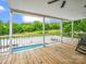 Covered patio with a view of the expansive backyard, pool, and surrounding greenery at 208 Wellington Dr, Lincolnton, NC 28092
