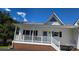 Charming home with a brick foundation, welcoming front porch, and crisp white siding at 2116 Mcclintock Rd # 123, Charlotte, NC 28205