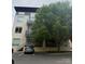 Modern building with balcony and ample parking, enhanced by mature trees, creating an appealing urban residential environment at 2116 Mcclintock Rd # 123, Charlotte, NC 28205