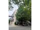 A contemporary building with a connecting walkway, lush trees, and ample parking at 2116 Mcclintock Rd # 123, Charlotte, NC 28205