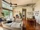 Bright living room featuring high ceilings, expansive windows, and an adjacent dining area at 2116 Mcclintock Rd # 123, Charlotte, NC 28205