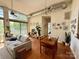 Open living space with a dining area, high ceilings, natural light, and a view of the greenery at 2116 Mcclintock Rd # 123, Charlotte, NC 28205