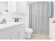 Bathroom with white cabinets, toilet, and shower curtain, creating a clean look at 221 Abner Rd, Stony Point, NC 28678