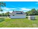Rear view of the home showcasing the manicured lawn and exterior structure at 221 Abner Rd, Stony Point, NC 28678