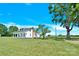 Charming white farmhouse with covered porch and lush green lawn under a bright blue sky at 221 Abner Rd, Stony Point, NC 28678