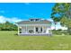 Quaint white home featuring a cozy front porch for a welcoming curb appeal at 221 Abner Rd, Stony Point, NC 28678