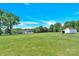 View of the home, outbuilding, and surrounding greenery on the property at 221 Abner Rd, Stony Point, NC 28678
