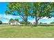 Scenic view of the home and outbuilding set among mature trees at 221 Abner Rd, Stony Point, NC 28678