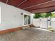 Covered back patio, accessible from the house via a sliding door, features classic brick pavers at 2502 Breuster Dr, Charlotte, NC 28210