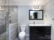 Elegant bathroom with a glass enclosed shower, marble counters, and a dark vanity with sleek hardware at 2502 Breuster Dr, Charlotte, NC 28210