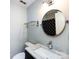 Bathroom features a toilet and sink with marble counter, round mirror, and black shower curtain at 2502 Breuster Dr, Charlotte, NC 28210