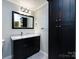 Bathroom features a marble vanity, dark cabinets and a tall linen cabinet for storage at 2502 Breuster Dr, Charlotte, NC 28210