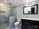 Elegant bathroom with a glass enclosed shower, marble counters, and a dark vanity with sleek hardware at 2502 Breuster Dr, Charlotte, NC 28210