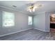 Bright bedroom features neutral walls, wood-look flooring, large windows, and attached bathroom at 2502 Breuster Dr, Charlotte, NC 28210