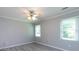 Cozy bedroom features neutral walls, wood-look flooring, and natural light from two large windows at 2502 Breuster Dr, Charlotte, NC 28210