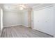Bright bedroom with a closet, ceiling fan, and light gray wood-look floors at 2502 Breuster Dr, Charlotte, NC 28210