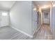 Long hallway features neutral paint, white trim, wood-look floors, and access to several rooms at 2502 Breuster Dr, Charlotte, NC 28210