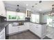 Bright kitchen featuring stainless steel sink, white cabinets and black and white backsplash with granite countertops at 2502 Breuster Dr, Charlotte, NC 28210