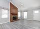 Open living room featuring a brick fireplace, high ceilings, and plenty of natural light at 2502 Breuster Dr, Charlotte, NC 28210